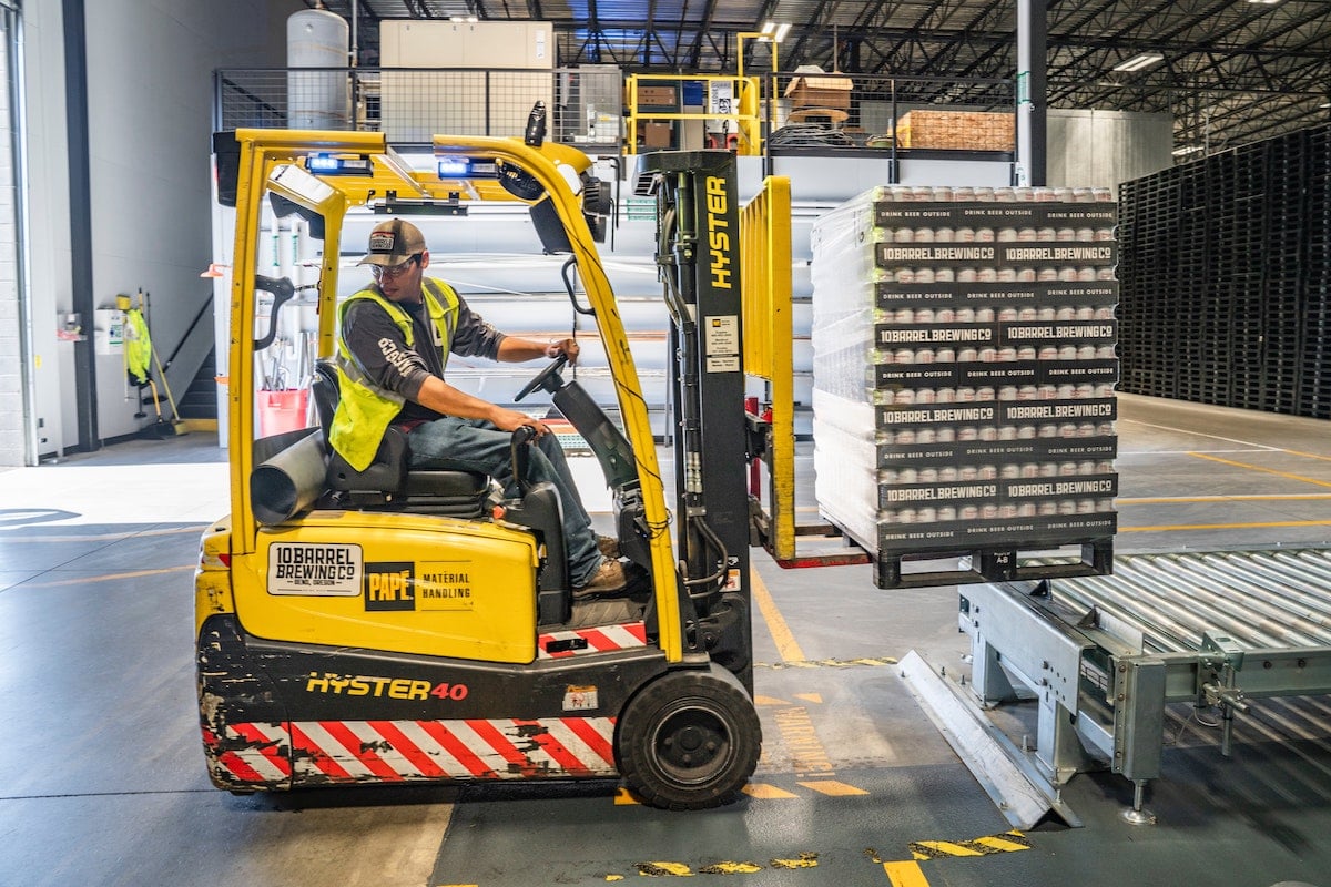 Fulfillment warehouse: a person Using Forklift.