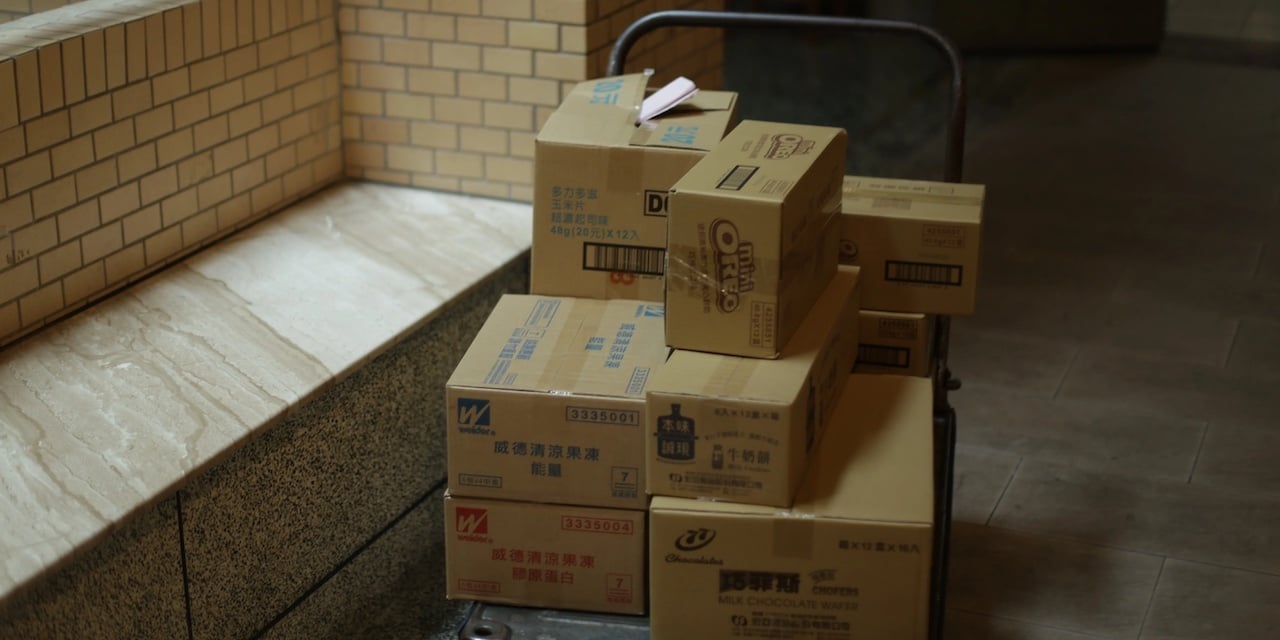 Parcels on a cart waiting to be collected.