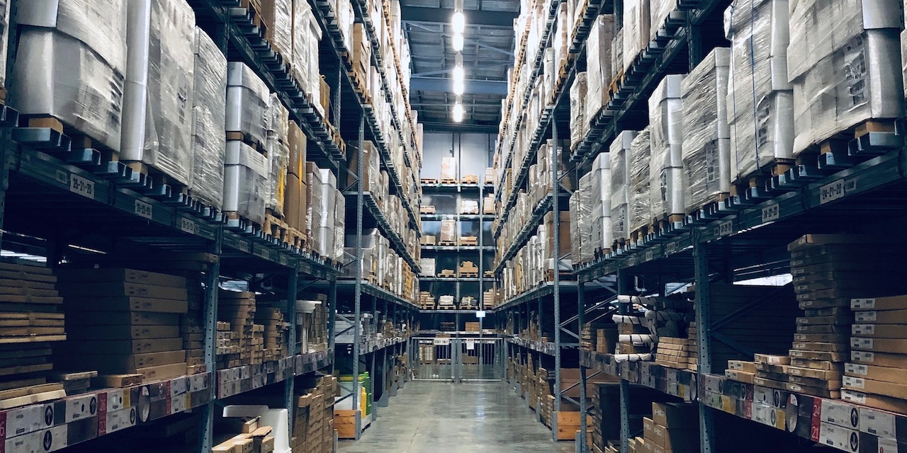 The interior of the fulfillment warehouse, full of packages located on high shelves.