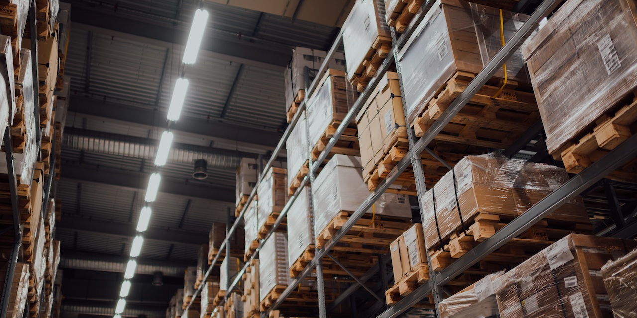 Shelves full of parcels in a fulfillment warehouse.